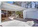 Spacious driveway and car port area leading to a garage and covered outdoor living space at 247 Heaton Park Dr, Atlanta, GA 30030