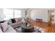 Bright living room featuring hardwood floors, neutral paint, decorative art, and a glimpse of the bathroom at 247 Heaton Park Dr, Atlanta, GA 30030