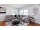 Inviting living room with neutral decor, hardwood floors, and abundant natural light from two windows at 247 Heaton Park Dr, Atlanta, GA 30030