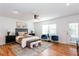 Bright main bedroom with hardwood floors, ceiling fan, and private exterior access at 247 Heaton Park Dr, Atlanta, GA 30030