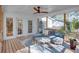 Cozy screened porch with a plush sectional, a ceiling fan, and great natural light for relaxed living at 247 Heaton Park Dr, Atlanta, GA 30030