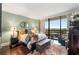 Bright bedroom with large windows offering neighborhood views, beautiful hardwood floors and a tranquil aesthetic at 2660 Peachtree Nw Rd # 11G, Atlanta, GA 30305