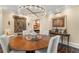 Traditional dining room boasting a round table with seating for six under a decorative chandelier at 2660 Peachtree Nw Rd # 11G, Atlanta, GA 30305