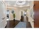 Elegant foyer boasts dark hardwood floors, neutral walls, and a contemporary chandelier for a luxurious entryway at 2660 Peachtree Nw Rd # 11G, Atlanta, GA 30305