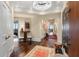 Elegant hallway with dark wood floors, chandelier, and an ornate side table and chairs at 2660 Peachtree Nw Rd # 11G, Atlanta, GA 30305