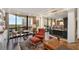 Open living room with beautiful hardwood floors, city views from floor-to-ceiling windows and elegant seating at 2660 Peachtree Nw Rd # 11G, Atlanta, GA 30305