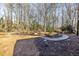 Backyard featuring a stone pathway, garden beds, and decorative statuary at 285 Glen Lake Dr, Sandy Springs, GA 30327