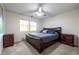 Bedroom featuring a dark wood bed frame with side tables and natural light at 285 Glen Lake Dr, Sandy Springs, GA 30327