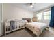 Comfortable bedroom featuring a crib, queen bed, ceiling fan, and natural light at 285 Glen Lake Dr, Sandy Springs, GA 30327