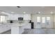 Bright kitchen featuring an island, white cabinetry, stainless steel appliances, and a gray backsplash at 285 Glen Lake Dr, Sandy Springs, GA 30327