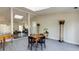 Bright living room with game table, columns, and view to stone-floored room at 285 Glen Lake Dr, Sandy Springs, GA 30327