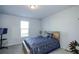 Cozy bedroom with soft carpet, natural light from the window, and a stylish bed at 301 Eleanora Xing, Loganville, GA 30052