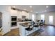 Well-lit kitchen featuring granite countertops, stainless steel appliances, and an island with seating at 301 Eleanora Xing, Loganville, GA 30052