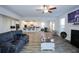 Bright living room with wood-look floors that flows to a bright white modern kitchen at 301 Eleanora Xing, Loganville, GA 30052