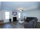 Bright living room featuring a fireplace, ceiling fan, and modern wood-look flooring at 301 Eleanora Xing, Loganville, GA 30052