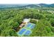 Aerial view showcasing tennis courts, community pool, and lush greenery at 4165 Liberty Trce, Marietta, GA 30066