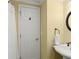 Cozy half bathroom features a white sink and toilet, bronze fixtures, and creamy colored walls at 4165 Liberty Trce, Marietta, GA 30066