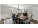 Elegant dining room features a wooden table, wainscoting, chandelier and neutral wall color at 4165 Liberty Trce, Marietta, GA 30066