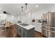 Modern kitchen with stainless steel refrigerator, white cabinetry, gray island, and eat-in area at 4165 Liberty Trce, Marietta, GA 30066