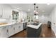 Bright kitchen with white cabinets, gray island, stainless steel appliances, and modern lighting at 4165 Liberty Trce, Marietta, GA 30066