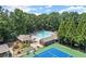 Aerial view of a community pool, tennis courts, and surrounding landscaping at 4165 Liberty Trce, Marietta, GA 30066