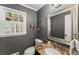 Stylish powder room with granite countertop, framed mirror, and window at 4165 Liberty Trce, Marietta, GA 30066