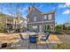 Large backyard patio with a fire pit and seating, ideal for entertaining guests outdoors at 586 Shoal Mill Sw Rd, Smyrna, GA 30082