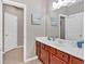 Bathroom vanity with cherry cabinets, framed mirror and natural-tone decor at 586 Shoal Mill Sw Rd, Smyrna, GA 30082