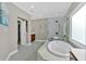 Luxurious bathroom showcasing a tub, shower, and tile flooring at 586 Shoal Mill Sw Rd, Smyrna, GA 30082