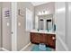 Bathroom boasts dark wood cabinets, dual sinks and is brightly lit with a window and modern light fixture at 586 Shoal Mill Sw Rd, Smyrna, GA 30082