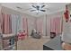 Neutral colored bedroom with ceiling fan and play area set up with comfortable seating at 586 Shoal Mill Sw Rd, Smyrna, GA 30082