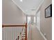 Upstairs hallway with crown molding and natural light from the large window at the end of the hall at 586 Shoal Mill Sw Rd, Smyrna, GA 30082