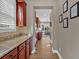 Hallway leads to an open-concept kitchen featuring granite countertops and cherry cabinets at 586 Shoal Mill Sw Rd, Smyrna, GA 30082