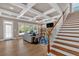 Open-concept living room with coffered ceiling, fireplace, large windows, and wood floors at 586 Shoal Mill Sw Rd, Smyrna, GA 30082