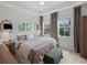 Bright bedroom featuring a large bed, windows, and a functional desk area at 166 Color Cir, Atlanta, GA 30317