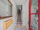 Bright foyer with a staircase, coat rack, and red door leading to the outside at 166 Color Cir, Atlanta, GA 30317