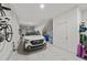 Well-lit two-car garage with white walls, overhead storage racks, and a car parked inside at 166 Color Cir, Atlanta, GA 30317