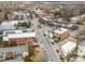 Aerial view showcasing a charming neighborhood with quaint shops and cafes along a bustling street at 166 Color Cir, Atlanta, GA 30317
