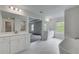 Elegant bathroom featuring double vanities, modern fixtures, and a luxurious soaking tub for a spa-like experience at 177 Haverling Pass, Hampton, GA 30228