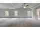 Expansive bedroom showcasing tray ceilings, plush carpeting, and ample natural light at 177 Haverling Pass, Hampton, GA 30228