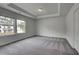 Inviting bedroom boasting plush carpet, tray ceiling, and large windows offering natural light at 177 Haverling Pass, Hampton, GA 30228