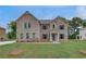 Charming two-story brick home featuring a manicured lawn and a classic design at 177 Haverling Pass, Hampton, GA 30228