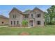 Well-maintained two-story brick home with a cozy front porch and green lawn at 177 Haverling Pass, Hampton, GA 30228