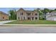 Two-story brick home with a well-manicured lawn and dark shutters on a sunny day at 177 Haverling Pass, Hampton, GA 30228