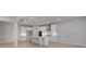Modern white kitchen with island, stainless steel appliances, and recessed lighting at 177 Haverling Pass, Hampton, GA 30228