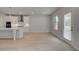 Modern kitchen with white cabinets, island, stainless appliances, and access to the outdoors at 177 Haverling Pass, Hampton, GA 30228