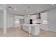 Bright kitchen with white cabinetry, large center island, and stainless steel appliances at 177 Haverling Pass, Hampton, GA 30228