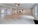 Open floor plan with modern kitchen, coffered ceiling, and spacious living area with light hardwood floors at 177 Haverling Pass, Hampton, GA 30228