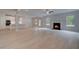 Spacious living room with a fireplace and hardwood floors, adjacent to the bright and modern kitchen at 177 Haverling Pass, Hampton, GA 30228