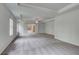 Spacious main bedroom featuring carpet, tray ceiling, a ceiling fan, and an attached bathroom at 177 Haverling Pass, Hampton, GA 30228
